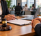 Employment Law Changes October 2026 – Solicitor discussing workplace rights and legal documents with a client in a professional office.